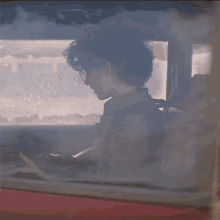 a person sitting in a car with smoke coming out the window