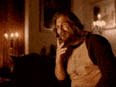 a man with long hair and a beard wears a shirt that says ' the big lebowski '