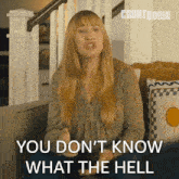 a woman sitting on a couch with the words " you don t know what the hell "