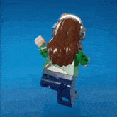 a lego figure wearing headphones and a green outfit
