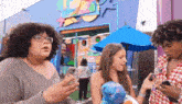 a group of people standing in front of a building with a sign that says toy story
