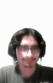 a pixelated image of a man wearing glasses and headphones .