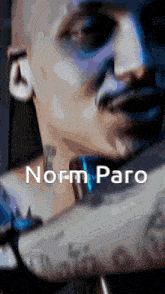 a close up of a person 's face with the words norm paro written below it