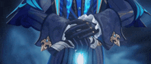 a man in a blue suit has his hands folded in front of him