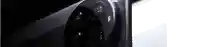 a close up of a black phone on a white surface .