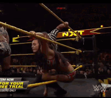 a wrestling ring with a sign that says ' com now for your free trial '