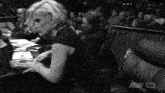 a black and white photo of a woman in a wrestling ring with aew hds on the bottom right