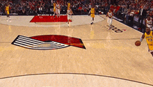 a basketball player with the number 23 on his jersey is dribbling the ball