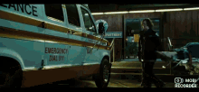 an ambulance is parked in front of a police department