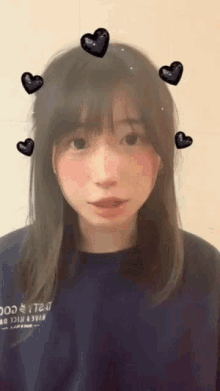 a girl with hearts on her head and a shirt that says t24