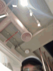 a person 's face is visible in a blurry photo with a pink frame in the background