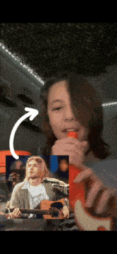 a young boy playing a guitar with a picture of kurt cobain