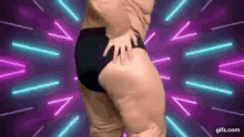 a fat man in black underwear is dancing on a neon background .