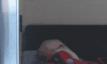 a blurred image of a person laying on a bed with a polka dot blanket