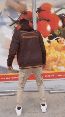 a man wearing a jacket that says dstrezzed co. on it