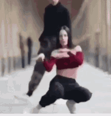 a man is carrying a woman on his shoulders while they dance .