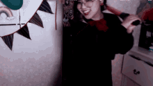 a woman with glasses is holding a bat in her hand