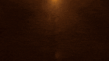 a dark background with a swirl of golden sparkles