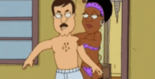a man and a woman are standing next to each other in a room .