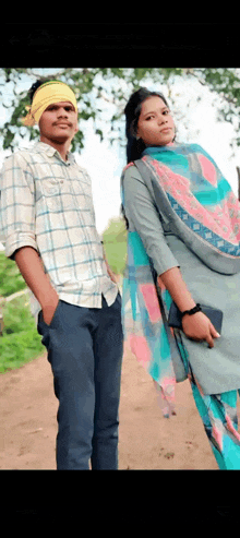 a man and a woman are posing for a picture together .