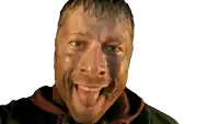 a man with his tongue sticking out is wearing a black sweatshirt