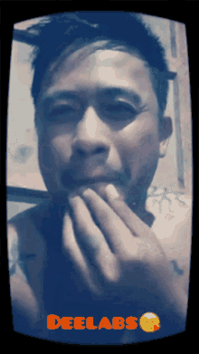 a man covering his mouth with his hands and the words deelabs on the bottom