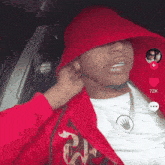 a man wearing a red hat and a red jacket has 72k followers on tiktok