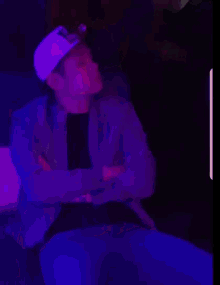 a man wearing a white hat with a purple background
