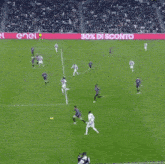 a soccer game is being played on a field with a banner that says enel