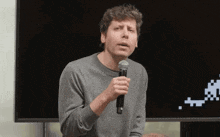 a man is holding a microphone and talking into it