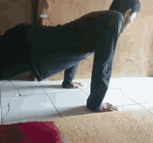 a man doing push ups on a tiled floor
