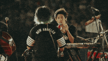 a man in a black shirt that says new angeles on it