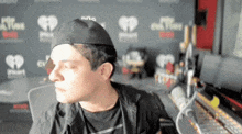 a man in front of a wall that says iheart radio