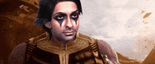 a man with black paint on his face is wearing a gold outfit
