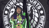 a woman is standing in front of a logo that says king sports