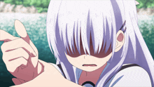 a girl with white hair is pointing her finger at the camera