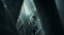 a person is standing in a dark room holding a stick in their hand .