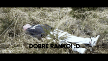 a person is laying in the grass with the words dobre ranko written on the bottom