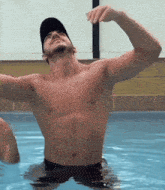 a shirtless man is swimming in a pool