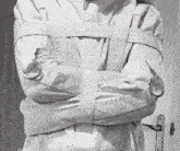 a person is wearing a straight jacket with their arms crossed