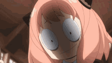 a close up of a girl with pink hair making a face