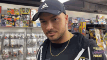 a man wearing a black adidas hat stands in front of a shelf full of toys