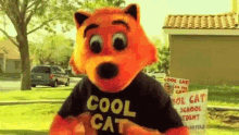 a mascot wearing a black shirt that says cool cat on it
