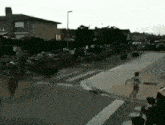 a man is running down a street with a skateboard