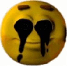a close up of a yellow smiley face with black tears coming out of its eyes .