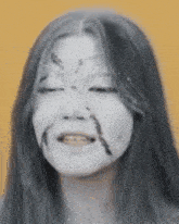 a close up of a woman 's face with white paint on it