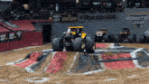 several monster jam trucks are on display in front of a crowd