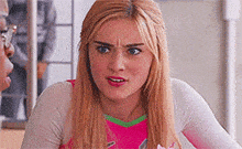 a woman is making a funny face while talking to a man in a room .