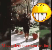 a woman is dancing in front of a yellow smiley face and the words miss ralentissement en faro