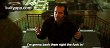a man is standing in front of a railing and says i 'm gonna bash them right the fuck in